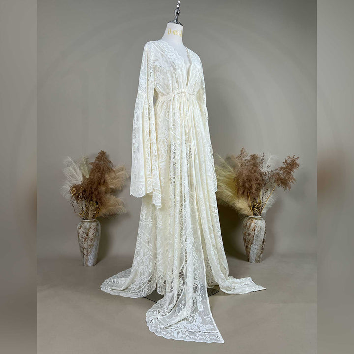A beige lace ,Abrota dress with long bell sleeves and a V-neckline, displayed on a mannequin. 