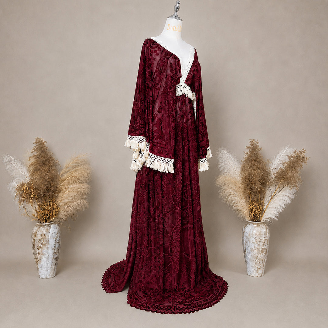 A Red wine,A bacche dress with a velvet cape and a white lace inner layer is displayed on a mannequin.