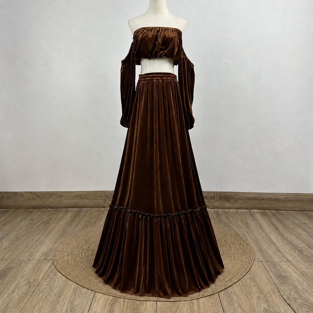 A KO-15,a Belisama velvet off-shoulder top and floor-length skirt are displayed on a mannequin. The two-piece outfit has a ruffled skirt hem.