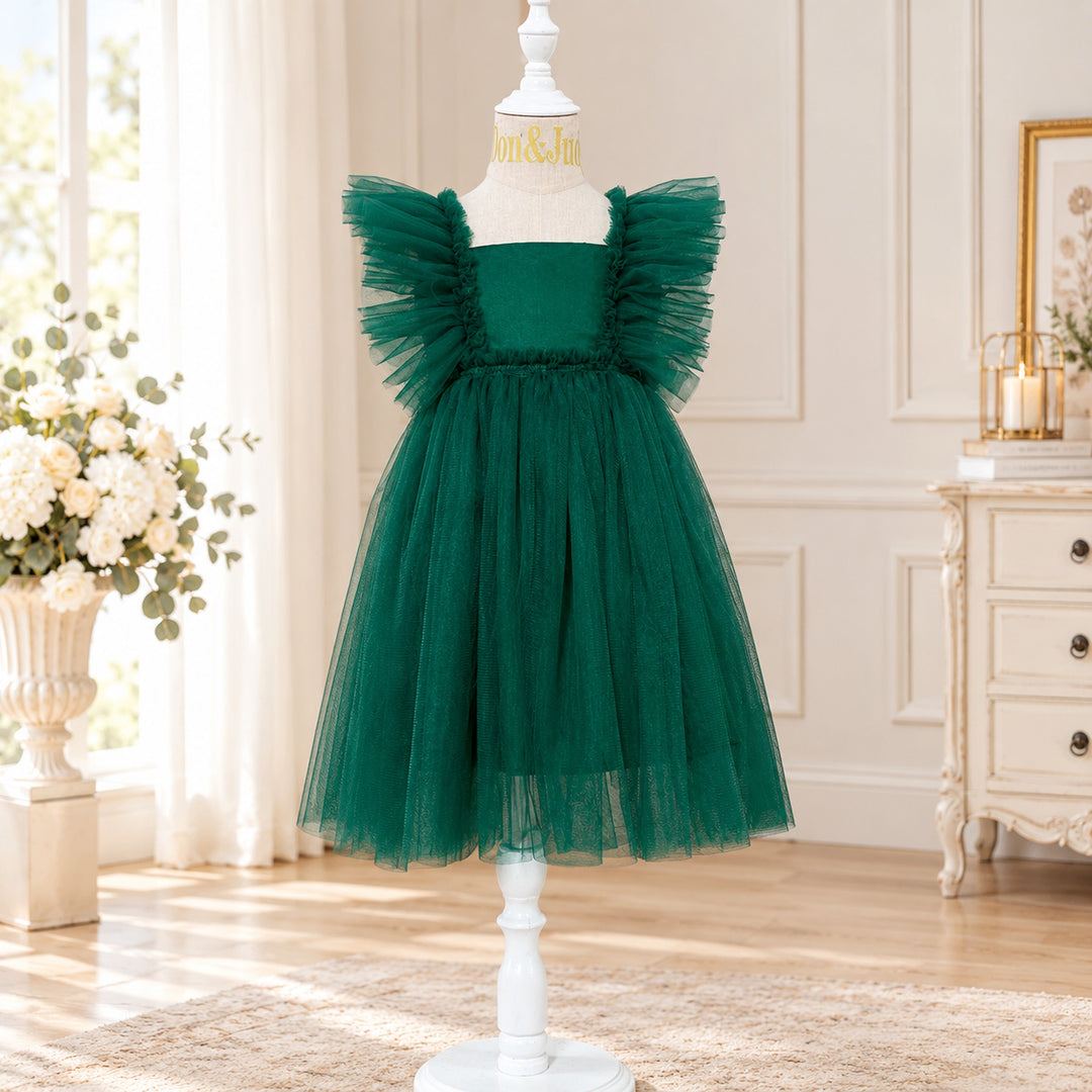 A Callisto green tulle dress on a mannequin with tulle ruffled shoulders