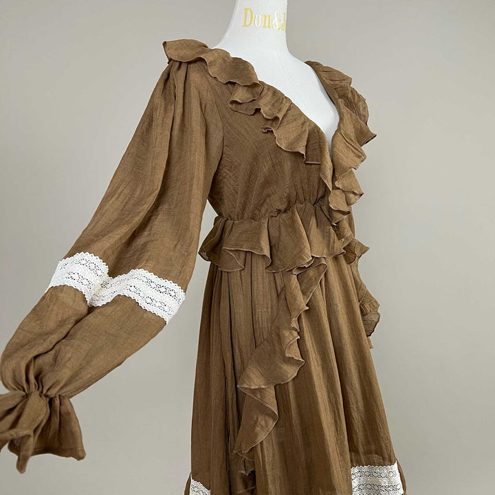 A side close-up of the Cassandra coffee dress, showing the ruffled neckline, white lace on the sleeve and the gathered cuff.