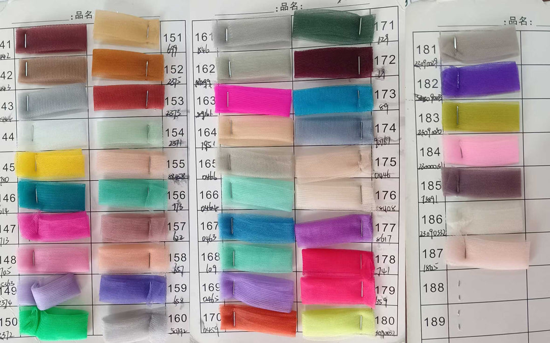 A large grid of small fabric swatches in many colors arranged on a white measurement chart with printed numbers. This is a Mila dress color-options reference image rather than a single product photo, so subject type is Color Swatch.
