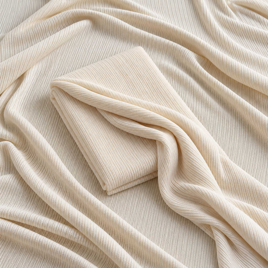 A beige ribbed knit fabric fills the frame, with a folded piece of the same fabric in the middle.